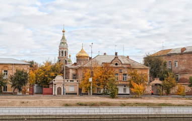 Ancient houses and church under the blue sky with clouds in the autumn afternoon.