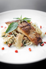 fresh fish fillet on mixed vegetable and parmesan spaghetti pasta