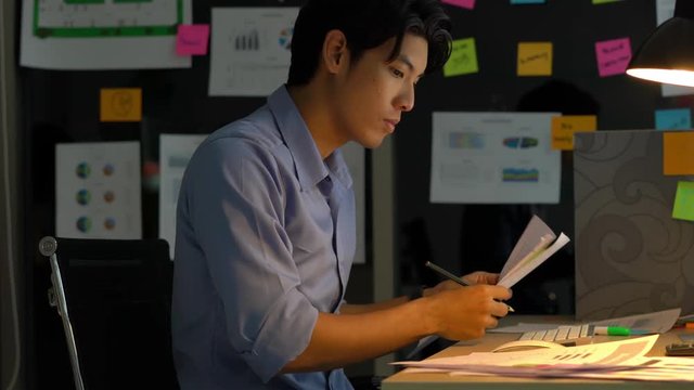 Businessman hard working with desktop computer to late night at office. Business people work overtime. Concept of salary man, fatigue and tired.