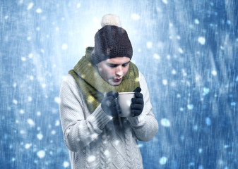 Handsome young boy shivering and trembling at snowstorm concept
