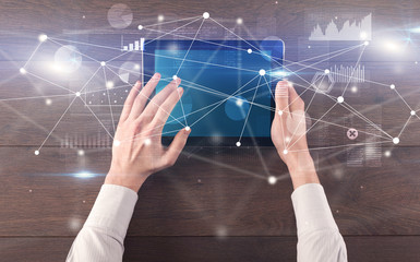 Hand using tablet with linking graphs charts  report and informational flow concept
