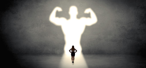 Woman standing and dreaming about a strong superhero