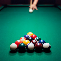 Adult male playing pool, snooker or billiard