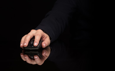 Hand using wireless mouse in a dark environment
