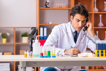 Young handsome biochemist working in the lab 