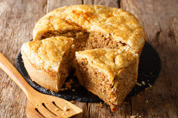 Tourtiere recipe of traditional French Canadian pie stuffed with pork, mashed potato and spices close-up. horizontal
