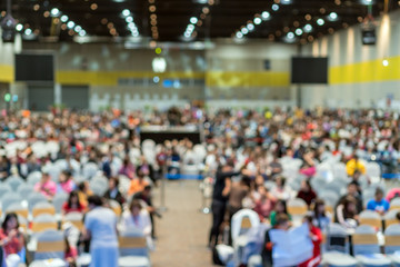Abstract blurred photo of conference hall or seminar room in Exhibition Center with speakers on the...