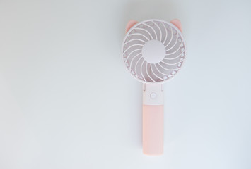 Pink portabe fan on the white background © magneticmcc