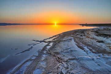 Beautiful sunrise on salt lake Chott el Djerid, Sahara desert, T