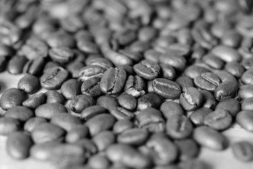 Roasted coffee beans on a wooden background. Black and white