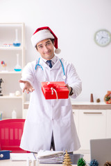 Doctor with gift box in the hospital