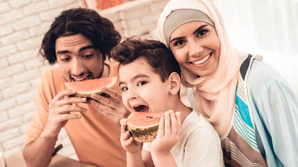 Happy Arabian Family Eating Watermelon in Kitchen.