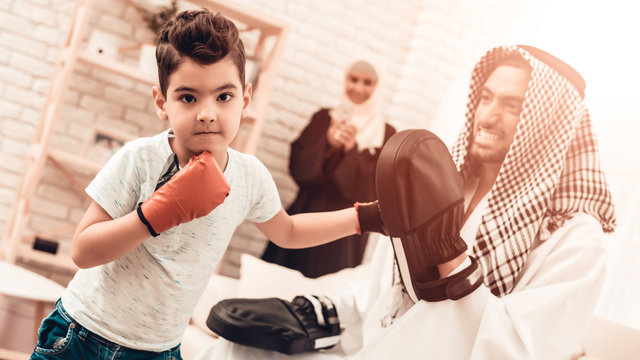 Arabian Boy Boxing with Young Father at Home.