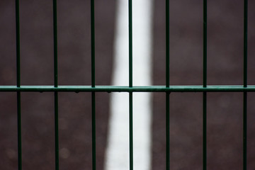 Background with metal fence and sports markings
