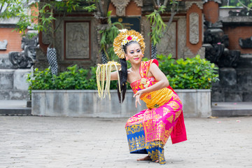 Pretty dancer performing traditional Balinese dance