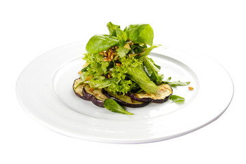 Aubergine grilled with vegetables on a white background. Vegetarian dish