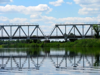 Fototapeta premium railway bridge over the river on the background of nature