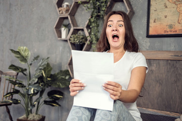 girl looks at the documents in surprise