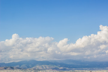 Fototapeta na wymiar mountain ridge background horizon landscape shape under clouds and empty blue sky, copy space