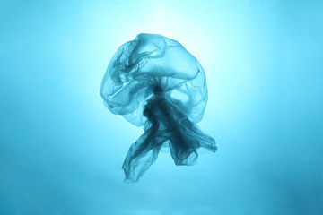 Drifting plastic bag in the form of a jellyfish in the world ocean. Concept of technogenic...