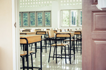 Back to school concept. School empty classroom, Lecture room with desks and chairs iron wood for studying lessons in highschool thailand without young student, interior of secondary education