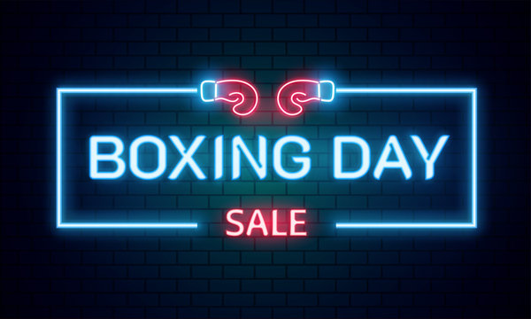 Neon text Boxing Day sale on brick wall background for advertising or promotion concept.