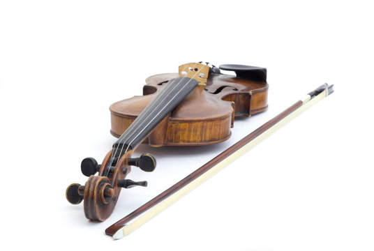 Old antique violin with a bow isolated on white background