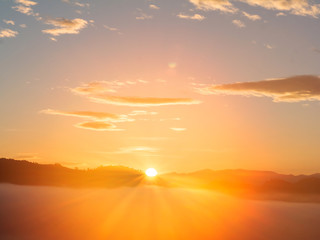 Sunrise with early morning sky scene covered in foggy