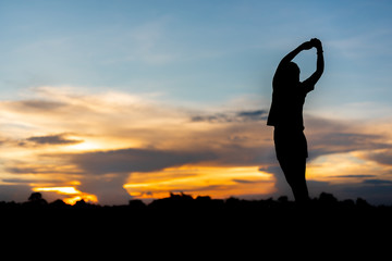 young woman warming up outdoors at park