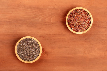 A photo of chia seeds and flaxseeds, shot from above on a rustic background with a place for text, superfood design template with copy space