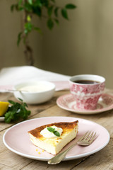 Healthy breakfast made from soft cottage cheese casserole with oatmeal and lemon zest, served with sour cream and mint.