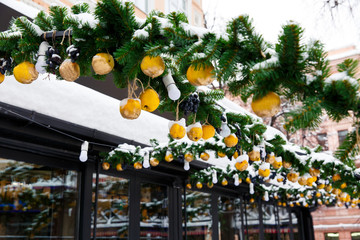 Christmas decoration on the street. trees with yellow lemons. Christmas concept exterior