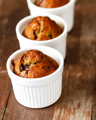Chocolate banana muffins on wooden background