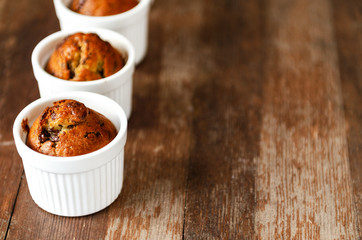 Chocolate banana muffins on wooden background
