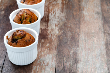 Chocolate banana muffins on wooden background