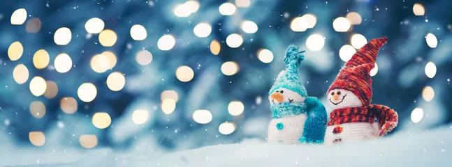Fotobehang little knitted snowmans on soft snow on blue background © candy1812