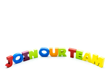Join Our Team text written with colourful wooden letters, isolated over white with copy space on the top.