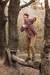 Handsome young guy in nature on an autumn day