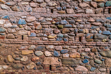 Old and cracked stone colored wall of some building