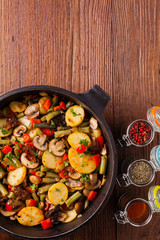 Fried pan vegetables, with mushrooms and dried tomatoes. Seasoned with a mix of herbs.
