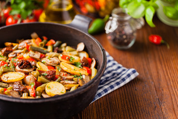 Fried pan vegetables, with mushrooms and dried tomatoes. Seasoned with a mix of herbs.