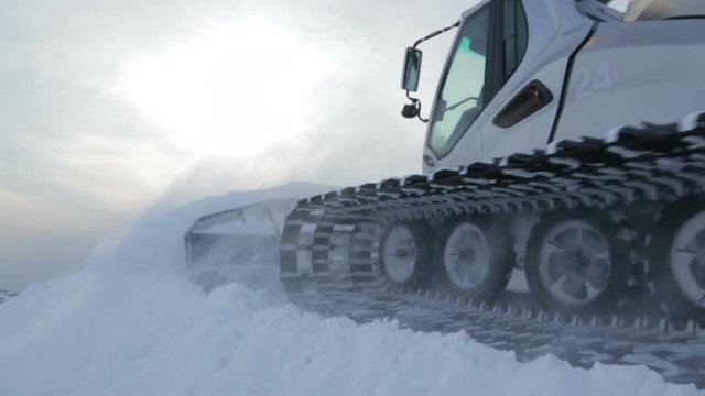 Snowcat moving on the mountain peak
