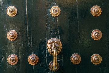 Wooden dark door with iron rivets background