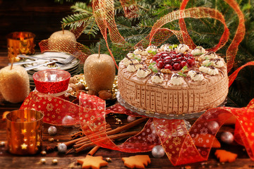 Christmas, nutty cake with cherries on wooden table