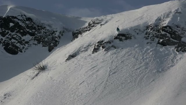 Freerider rolls skiing snowy peak