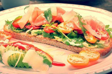 Avocado sandwich on fresh bread with arugula