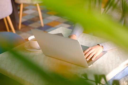 Close up shot businesswoman working on a laptop with her hands in the office with a modern design. - Powered by Adobe