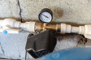 Plumbing parts. Pressure gauge and pressure switch in plastic pipe