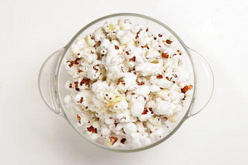 Popcorn in a transparent plate  isolated on white background
