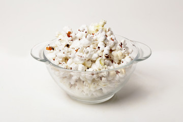 Popcorn in a transparent plate  isolated on white background